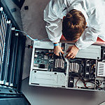 IT Engineer Servicing Part of a Supercomputer.