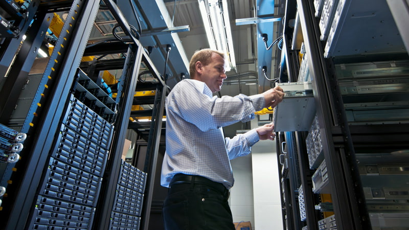 IT administrator installing a new rack mount server.