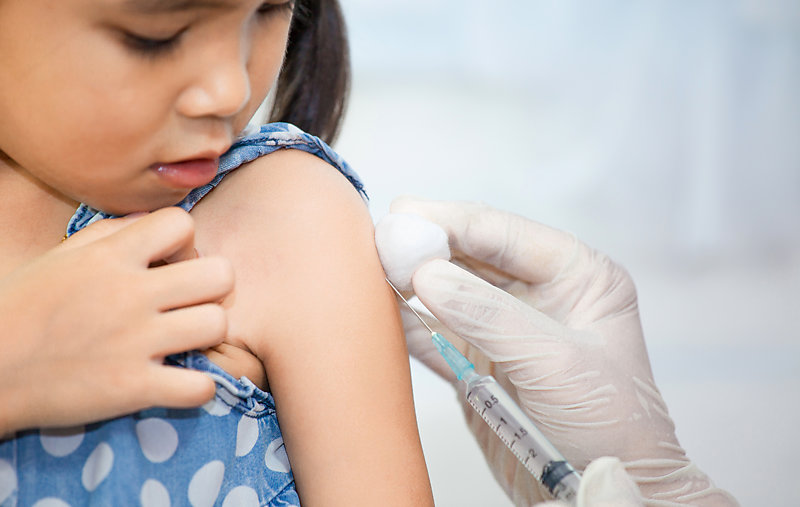 Little being vaccinated in the arm.